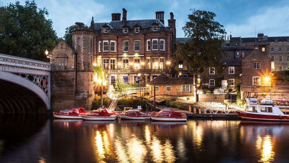 Small boats moored next to a bridge