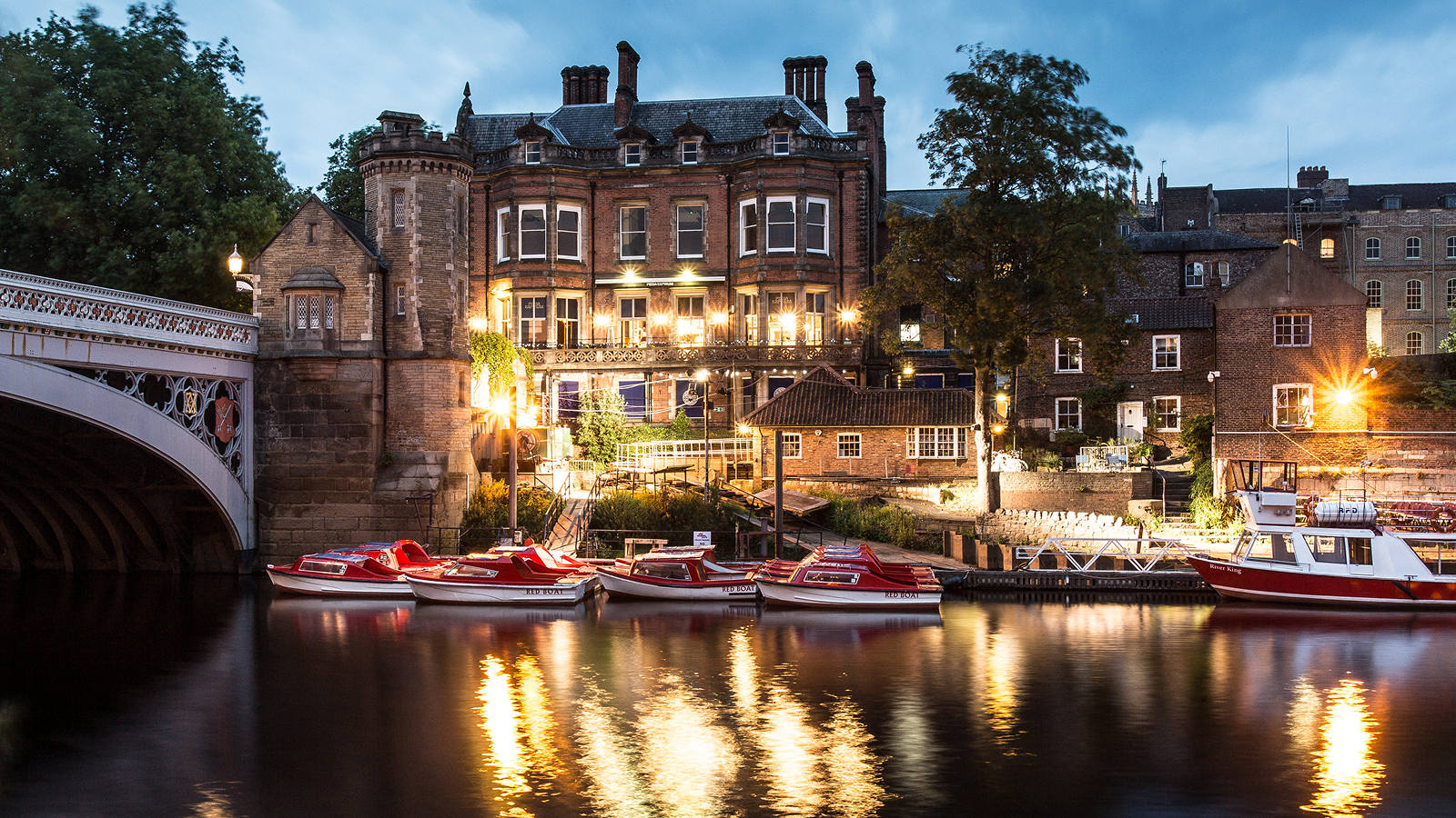 Small boats moored next to a bridge